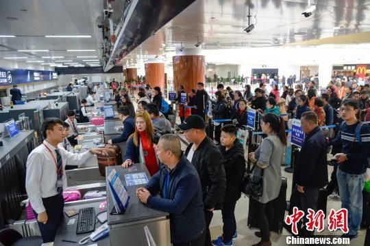 图为旅客在海口美兰国际机场排队办理登机牌。 洪坚鹏 摄