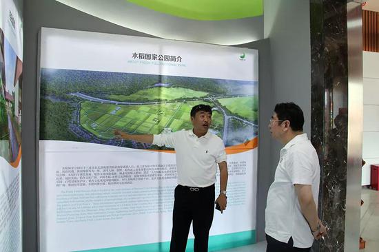 王路副省长听取水稻国家公园副总经理杨言卓（图左）汇报园区概况