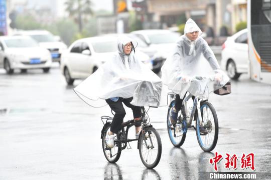 市民在降雨天气出行。　张浪 摄