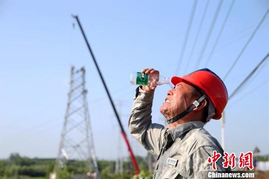 湖北多地创用电负荷新高，图为高温下的电力检修人员（资料图）　刘晓飞　摄