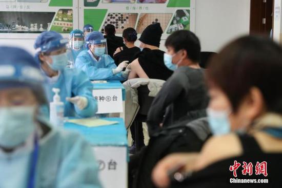 资料图:1月8日,在北京市海淀区学院路街道临时接种点内,医护人员为接种者注射疫苗。 中新社记者 蒋启明 摄