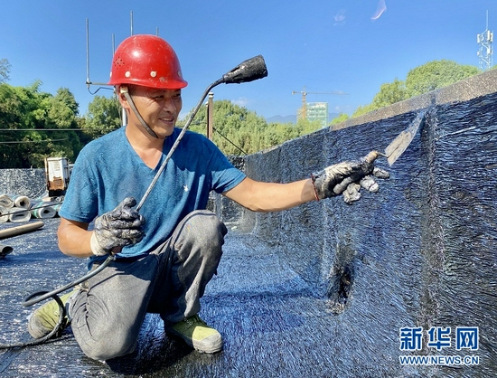 图为恩施市六角亭街道办事处老旧小区改造现场，工人在施工作业。新华网发 张远明摄