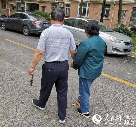赵婆婆只能在老伴的搀扶下行走。(周雯 摄)