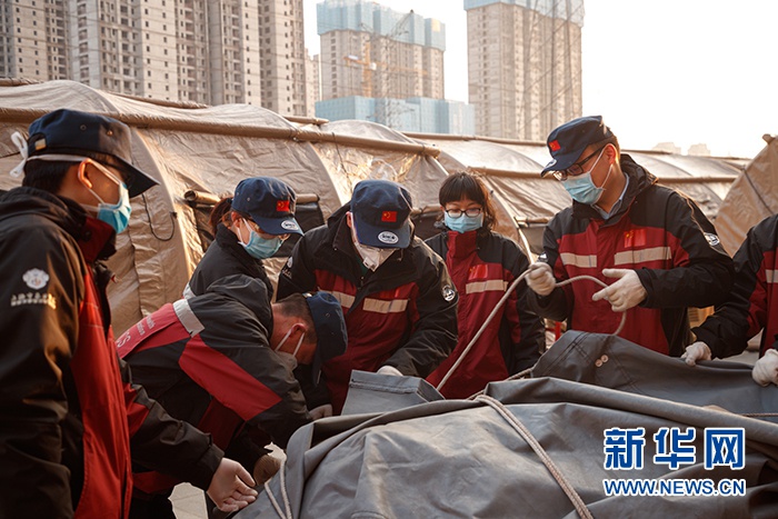 图为武汉客厅方舱医院医务工作者卸载医疗器械和物资。新华网发 董宏祥摄