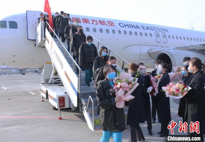 图为西宁机场工作人员为归来的医疗队队员献花。　孙睿 摄