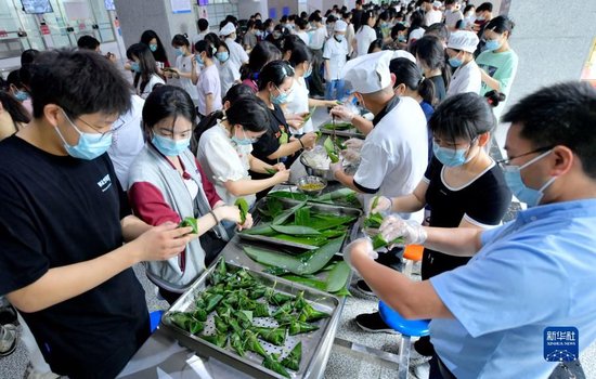 6月4日，湖北省宣恩县一中的高三学生在包粽子。