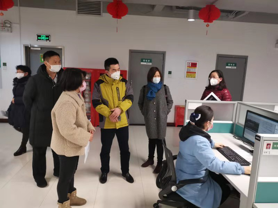 1月24日农历除夕，邮储银行湖北省分行副行长蔡平选（中）前往光谷金融港检查省分行营运中心防疫工作。