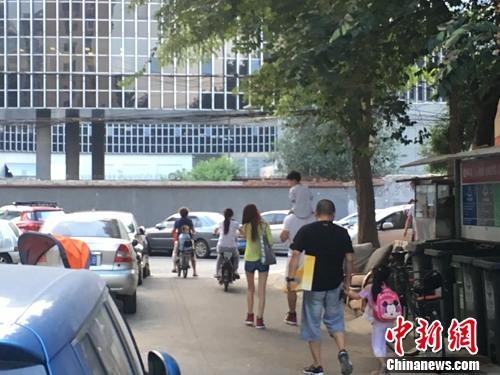 北京某幼儿园门口，家长接孩子放学。汤琪 摄