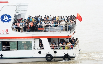 轮渡迎来了节日客流高峰，一天客流量比平时多3倍以上。许多外地游客及本地市民乘坐轮渡观赏江景。记者李子云 摄