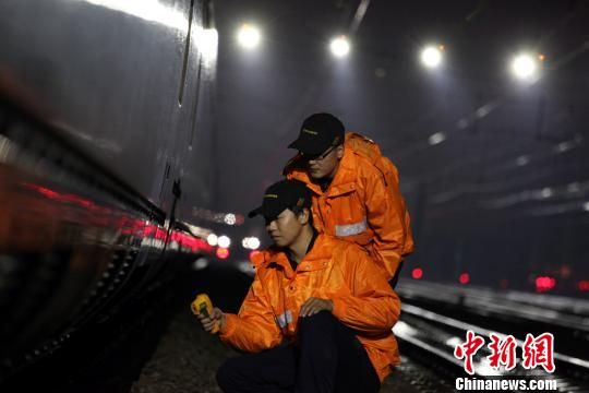 圖為“動(dòng)車保姆”冒著嚴(yán)寒進(jìn)行夜間檢修保溫工作?！≡S輝 攝