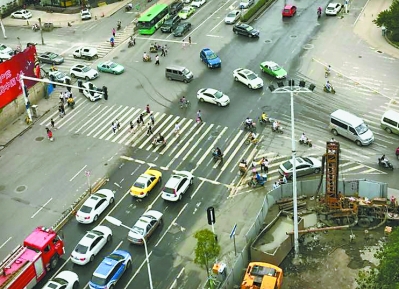唐家墩路马场路路口汇集了5个方向的车辆,交通十分“繁忙”。图中右下角即是人行天桥工地 记者杨荣峰 摄