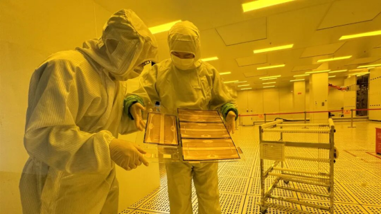 湖北通格微电路科技有限公司无尘车间内，工作人员正在检测玻璃基板上的线路分布。（资料图）