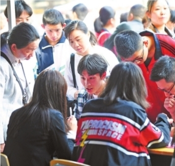 家长和考生在武汉市六十八中咨询点的十二中展位咨询 记者彭年 摄