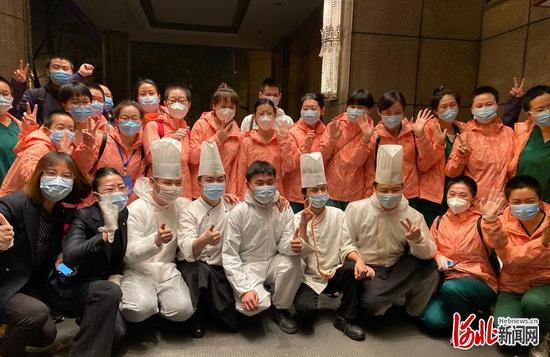 天还没亮,武汉香格里拉大酒店门口,河北支援湖北医疗队队员和酒店工作人员道别,登车前往天河机场,准备返程。(湖北日报记者柯皓摄)
