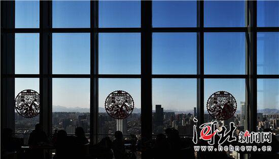 2月12日,从石家庄希尔顿酒店自助餐厅向外望去,湛蓝的天空映衬着喜庆的窗花,远山清晰可见。 记者赵海江摄