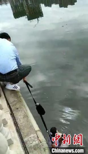 民警把腰带和包接在一起施救 视频截图
