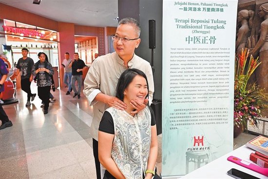 图③ 当地市民体验中医正骨。