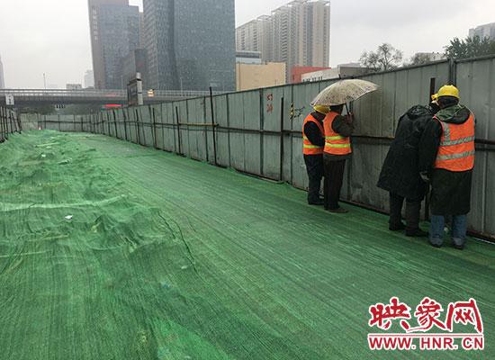 工人冒雨拆除围挡,给围挡瘦身