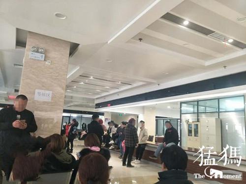 （淮濱縣為民服務中心2樓西側由于座椅有限，坐在衛計委窗口柜臺等待辦理民政手續的居民）