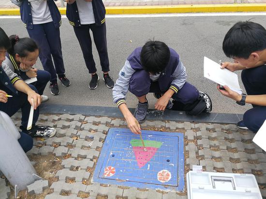 研学结束后，小组成员选取校园一角绘制墙绘图案