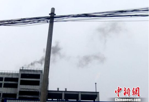 高聳的煙囪不時冒出黑煙 吳揚 攝