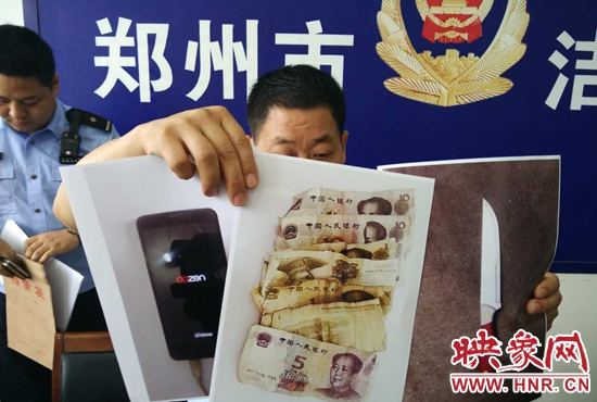 民警展示男子抢的29元钱和一部手机