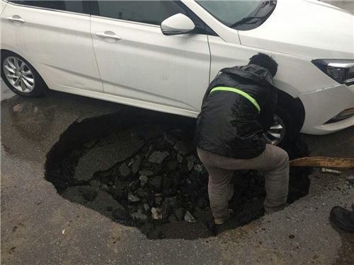 路面塌陷，轎車被卡
