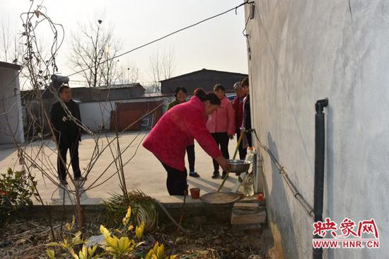 群众正在使用水龙头接水