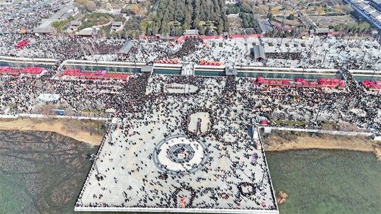 　　航拍视角下，淮阳太昊陵景区的伏羲文化广场人头攒动、摩肩接踵，密密麻麻的游客会聚于此，尽显新春庙会的火爆人气。
