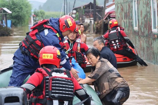 8月4日，在黑龙江省尚志市一面坡镇万山村，哈尔滨市森林消防支队的消防员在解救被困村民