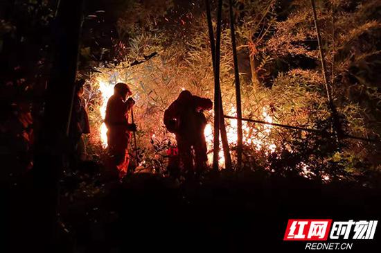9月25日晚,山火死灰复燃,武警衡阳支队组织增援力量上山扑救。