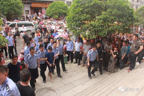 ▲图为办案民警押解犯罪嫌疑人指认现场