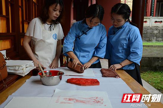 来自湖南大学的在校学生在岳麓书院体验雕版印刷的魅力。