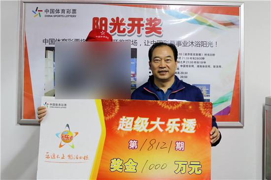 湖南省体彩中心主任曹品质（右）为大奖得主颁奖。