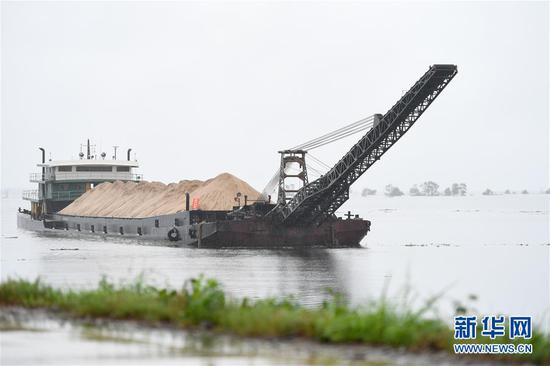 在益阳市大通湖区东大堤附近水域，一艘船采取“以船代仓”方式储备防汛物资（7月8日摄）。新华社记者陈泽国摄