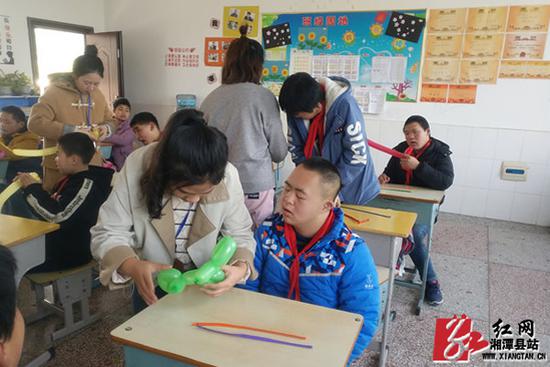 “一对一”指导学生进行手工制作。