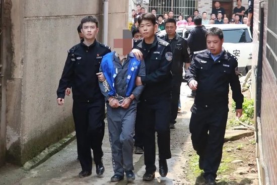  民警押解犯罪嫌疑人指认现场