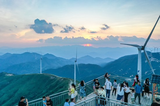 (云冰山景区,游客在山巅观光游玩。彭华 摄)