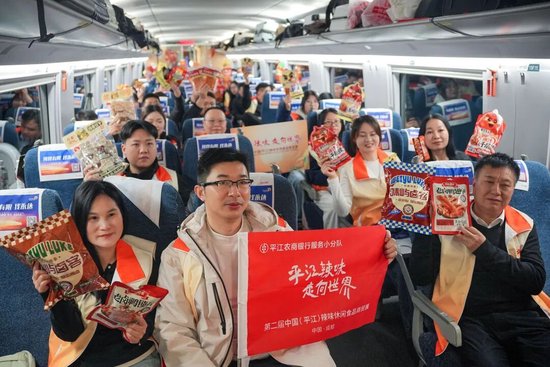 ▲“平江辣味·走向世界”专列载着平江30多家辣味食品企业代表奔赴成都。（黄淼章/摄）