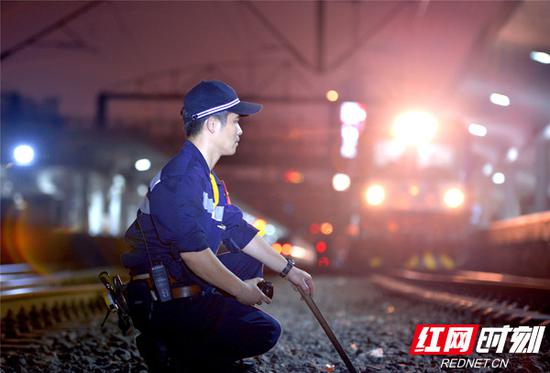 冬末时节，客列检作业人员夜间接送旅客列车。