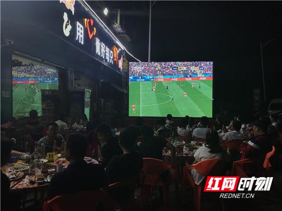 不少餐饮店都增设户外投影,以供食客们看球。