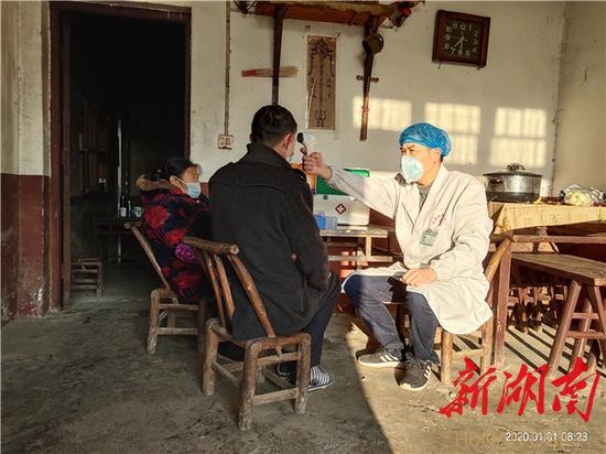 (乡村医生周白龙每天要上门为每名居家隔离对象测两次体温)
