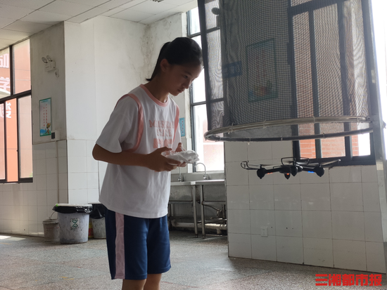 (宁乡回龙铺镇中心小学五年级学生林紫萱,利用课余时间训练飞行无人机。)