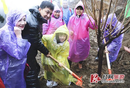 著名主持人李锐和家人种植许愿树。文丽贵 摄