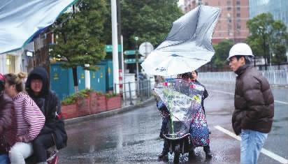 长沙市蔡锷中路与解放西路交会处，电动车的遮雨伞被大风吹翻。记者 郭立亮 唐俊 摄