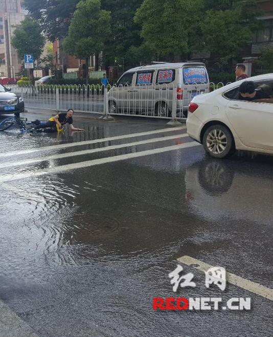 7：56，一女子戴耳机骑车经过，避让路上的积水，与正经过此路段的汽车刮擦，险些酿成惨祸。