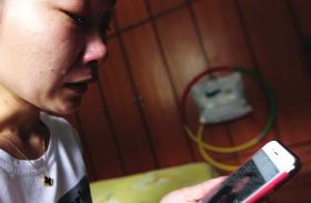 
	5月22日，余曼仙看着手机上未婚夫谭小虎的照片又哭了起来。图/潇湘晨报记者 金林

