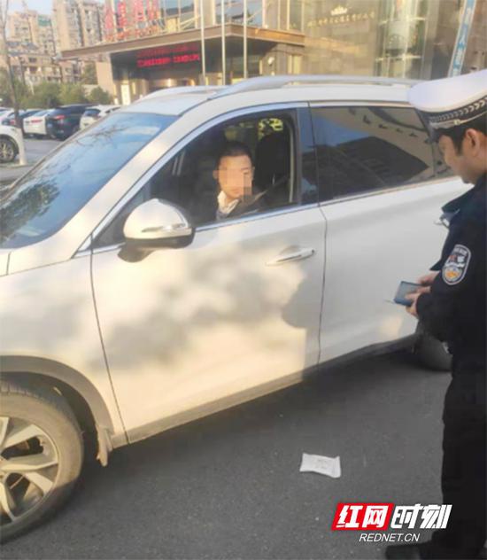 车主打开车窗抛物,被交警支队特勤大队巡逻民警抓个正着。