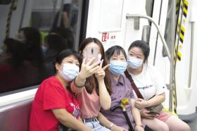 长沙地铁3号线,家住恒大雅苑的老人李萍在两个孙女的陪同下体验地铁出行。