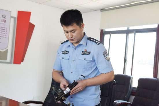 图为办案民警展示犯罪嫌疑人作案工具。